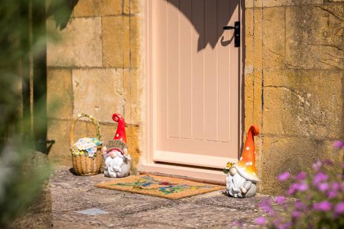 a group of figurines standing outside of a door at Broadway Scandi Chic Authentic Cottage in Broadway