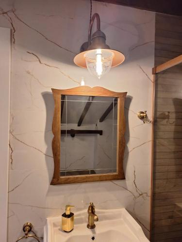 a bathroom with a mirror and a sink at Parque Remonta in Santander
