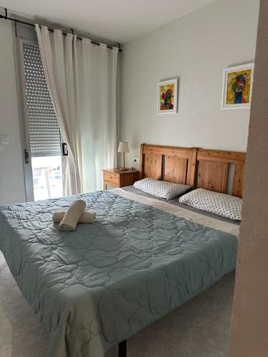 a bedroom with a large bed with two pillows at Riviera Ático in Miami Platja