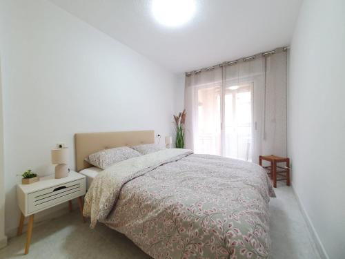 Una habitación blanca con una cama y una ventana en Casa Victor, en San Pedro del Pinatar