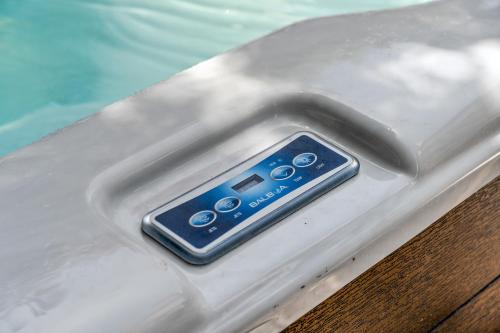 a remote control sitting on the side of a inflatable at Gorgeous Santa Cruz Villa - Modern Beachside Paradise with NEW Hot Tub & Fast Wi-Fi in Santa Cruz
