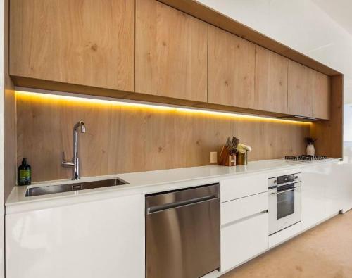 a kitchen with white cabinets and a sink at SOHO PV - 1007 Best and Brand New Condo in Puerto Vallarta