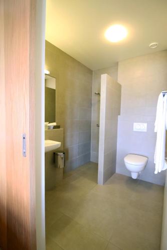 a bathroom with a toilet and a sink at Gistihúsið - Lake Hotel Egilsstadir in Egilsstadir