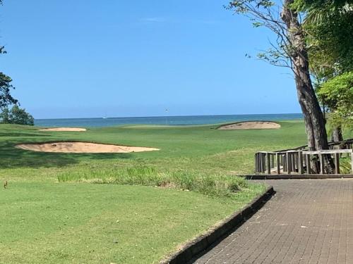 a golf course with two sand dunes and a tree at Villa Maravilla Estates, Tamarindo Beach, Prime Location, Family & Friends in Tamarindo
