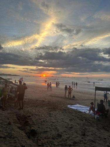 a group of people on the beach at sunset at Villa Maravilla Estates, Tamarindo Beach, Prime Location, Family & Friends in Tamarindo