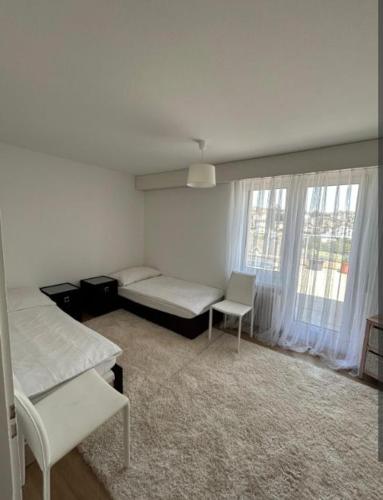 a bedroom with a bed and a chair in it at Rooftop ink Parking in Lucerne