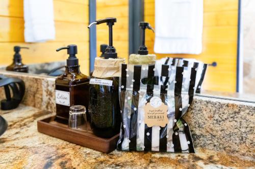 a group of bottles of alcohol sitting on a counter at Meraki Escape in Brevard