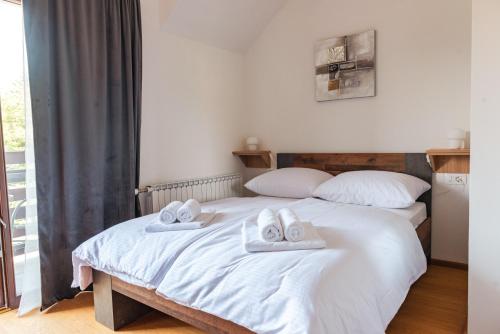 a bedroom with two beds with towels on them at Rooms Enter Ogulin in Oštarije