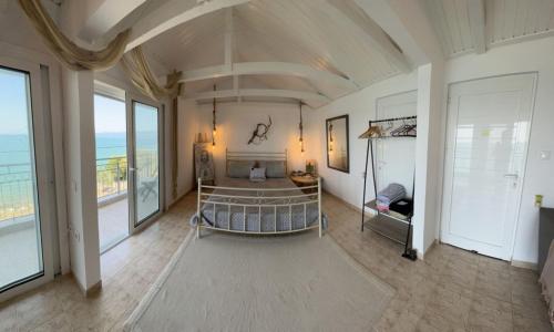 a large room with a bed and some windows at ARTE MARE d'Irene in Spárton
