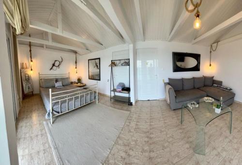 a living room with a couch and a table at ARTE MARE d'Irene in Spárton