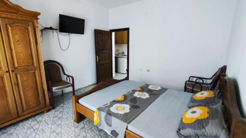 a bedroom with a bed with a bedspread with flowers on it at Tanja Terrace Appartments Dobre Vode in Dobra Voda