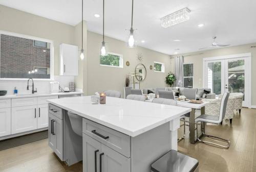 a kitchen and living room with a table and chairs at Gray Lux Hse 3BR 3 and half Ba MedCenter DownTWN HotTub in Houston
