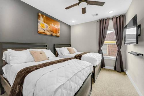 a bedroom with two beds and a window at Gray Lux Hse 3BR 3 and half Ba MedCenter DownTWN HotTub in Houston