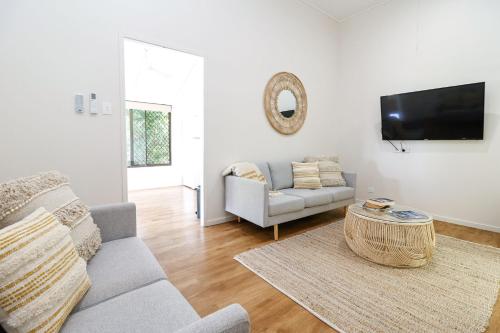 a living room with a couch and a table at Oasis on Farnborough in Yeppoon