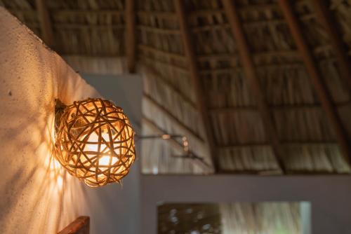a ball of light hanging on the side of a wall at Casa Chula Hotel Boutique Frente al Mar in Tierra Blanca