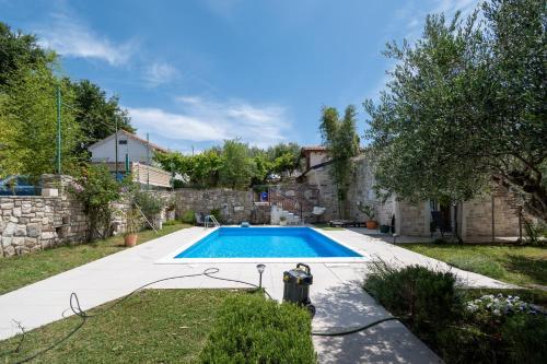 a swimming pool in the yard of a house at Family friendly house with a swimming pool Radovin, Zadar - 21307 in Ražanac
