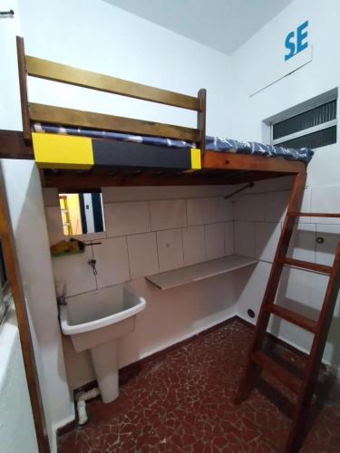 a bathroom with a bunk bed and a sink at Hostel Vergueiro in São Paulo