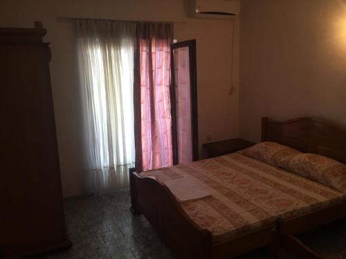 a bedroom with a bed in front of a window at Tanja Terrace Appartments Dobre Vode in Dobra Voda