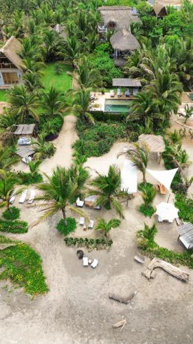 an aerial view of a resort on a beach with palm trees at Casa Chula Hotel Boutique Frente al Mar in Tierra Blanca