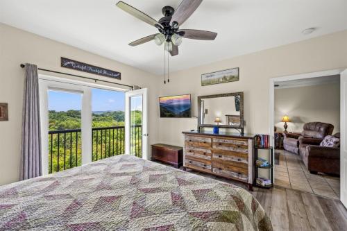 a bedroom with a bed and a view of a balcony at Smoky Mountain View Condo- Hot Tub, Indoor Pool, Walking Path, Playground in Pigeon Forge