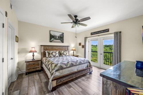 a bedroom with a bed and a ceiling fan at Smoky Mountain View Condo- Hot Tub, Indoor Pool, Walking Path, Playground in Pigeon Forge