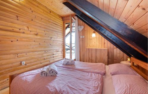 a bedroom with two beds in a wooden cabin at Beautiful Home In Samobor With Kitchen in Samobor