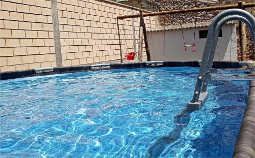 a large swimming pool with a water slide at Casa El Obrador in Arguedas