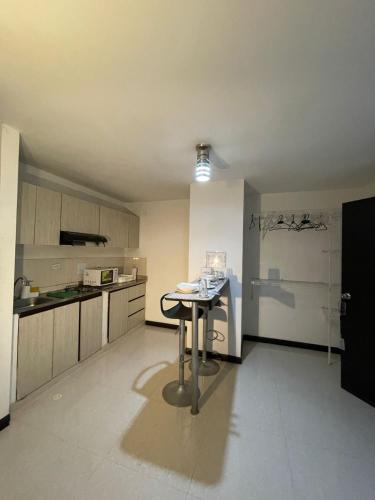 a kitchen with a table in the middle of a room at Hotel Plaza Norte Cali in Cali