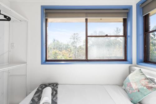 a white couch in a room with a window at Modern Single Room - Nearby Stations & Eateries - Shared Bathroom in Blacktown