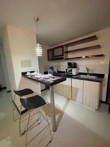 a kitchen with a table and chairs in a room at Hotel Plaza Norte Cali in Cali