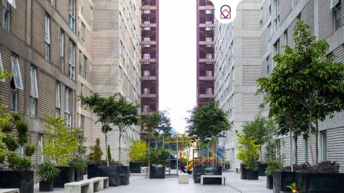a city street with trees and benches and tall buildings at New Chic Condo with Gym Access & Private Roof in Mexico City