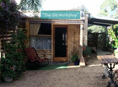 a building with a sign that reads the old workshop at A La Folly too The Old Workshop in Murray Bridge