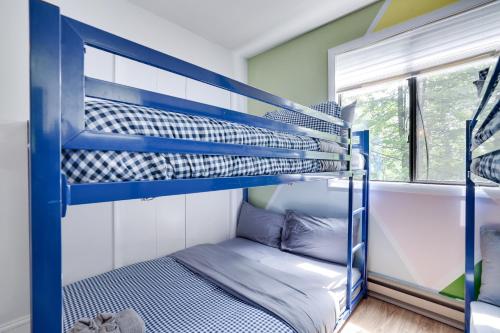 two bunk beds in a room with a window at Green Acres Nature Escape in Long Pond