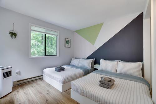 a bedroom with two beds and a window at Green Acres Nature Escape in Long Pond