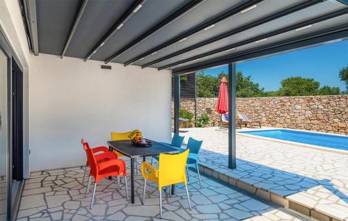 a patio with a table and chairs next to a swimming pool at Nice Home In Trbounje With Wifi in Trbounje