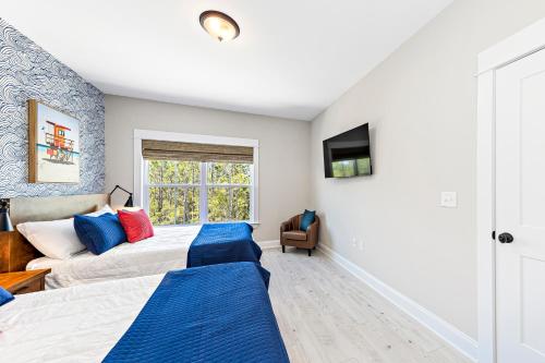 a bedroom with two beds and a window at Whiskey Sands - Luxury by Gulf State Park, Great Views, Walk to Beach and Restaurants, Beautiful Pool, Fenced Yard! in Orange Beach