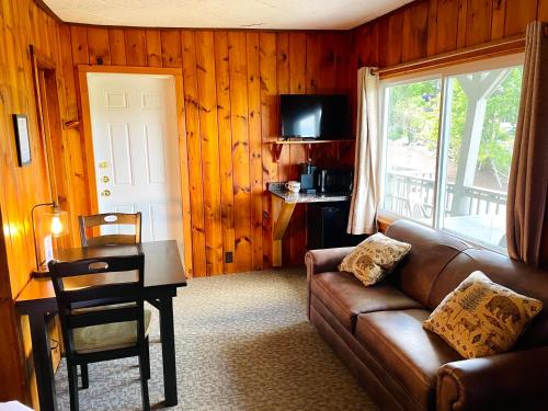 a living room with a couch and a table at Waters Edge Lodge in Lake George