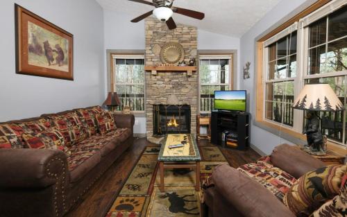 a living room with a couch and a fireplace at Honey Bear Heaven in Gatlinburg