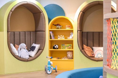 a childs room with two archways in a house with a toy car at The Westin Langkawi Resort & Spa in Kuah