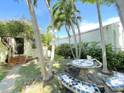 a backyard with a table and palm trees at Private guest house in the heart of Miami! Surrounded by Miami's HOT spots! in Miami