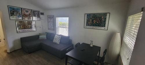 a living room with a blue couch and a table at Private guest house in the heart of Miami! Surrounded by Miami's HOT spots! in Miami