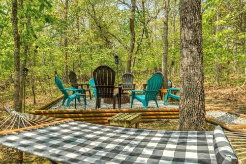 a group of chairs sitting around a table in the woods at Hideaway Lake Chalet in Innsbrook