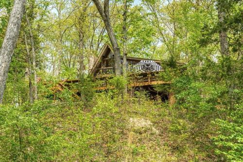 a wooden bridge in the middle of a forest at Hideaway Lake Chalet in Innsbrook