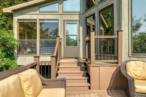 a screened in porch of a house with two chairs at Linden Lakefront Retreat with Kayaks in Innsbrook