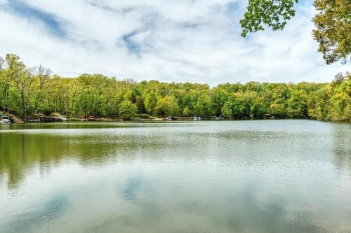 a large lake with trees in the background at Acorn Lake Lodge On Lake Aspen in Innsbrook