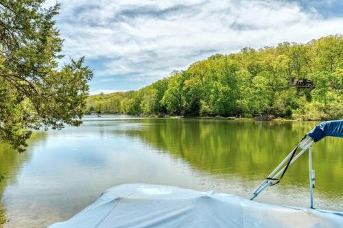 a boat on a lake with trees in the background at Acorn Lake Lodge On Lake Aspen in Innsbrook