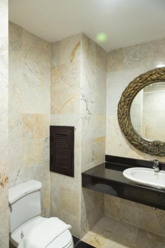 a bathroom with a toilet and a sink at Gassan Panorama Golf Club in Ban San Pa Hiang