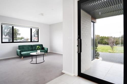 a living room with a green couch and a table at Murray Home Collector in Collector
