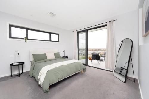 a bedroom with a bed and a large window at Murray Home Collector in Collector