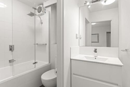 a bathroom with a sink and a toilet and a mirror at Mama Koko in Melbourne